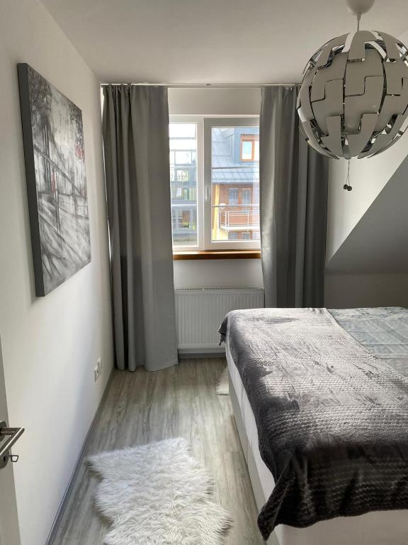 sypialnia z łóżkiem i oknem w obiekcie Deluxe apartmán Liščí kopec w Vrchlabi