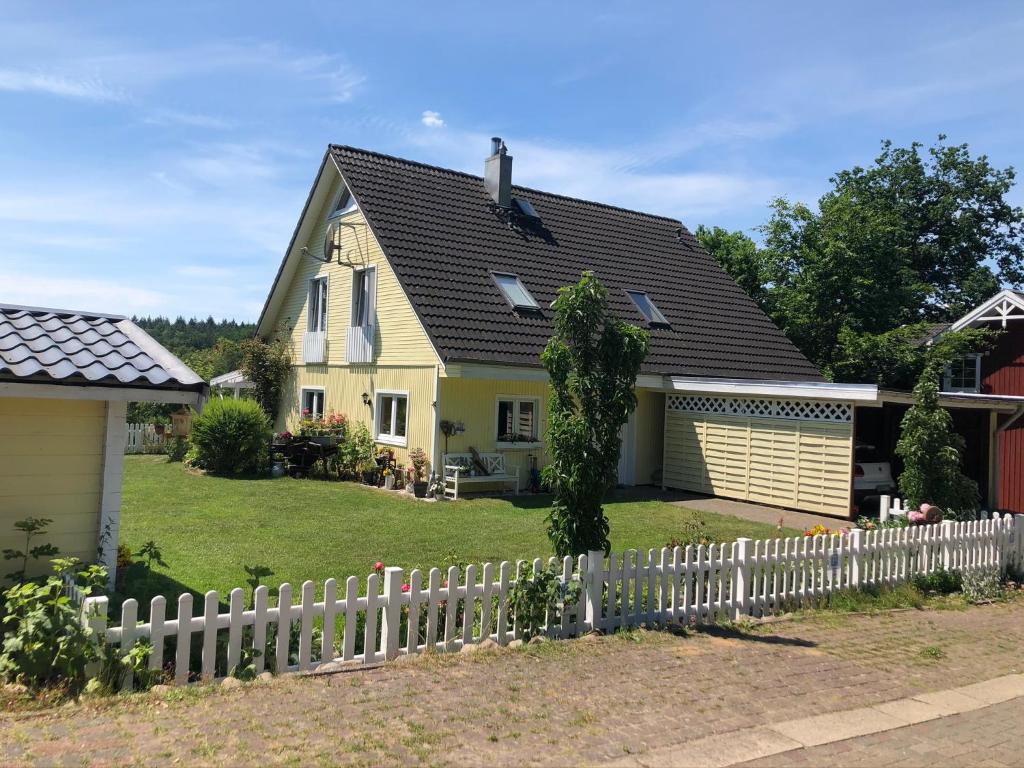 a house with a white picket fence at Lüly in Lütjensee