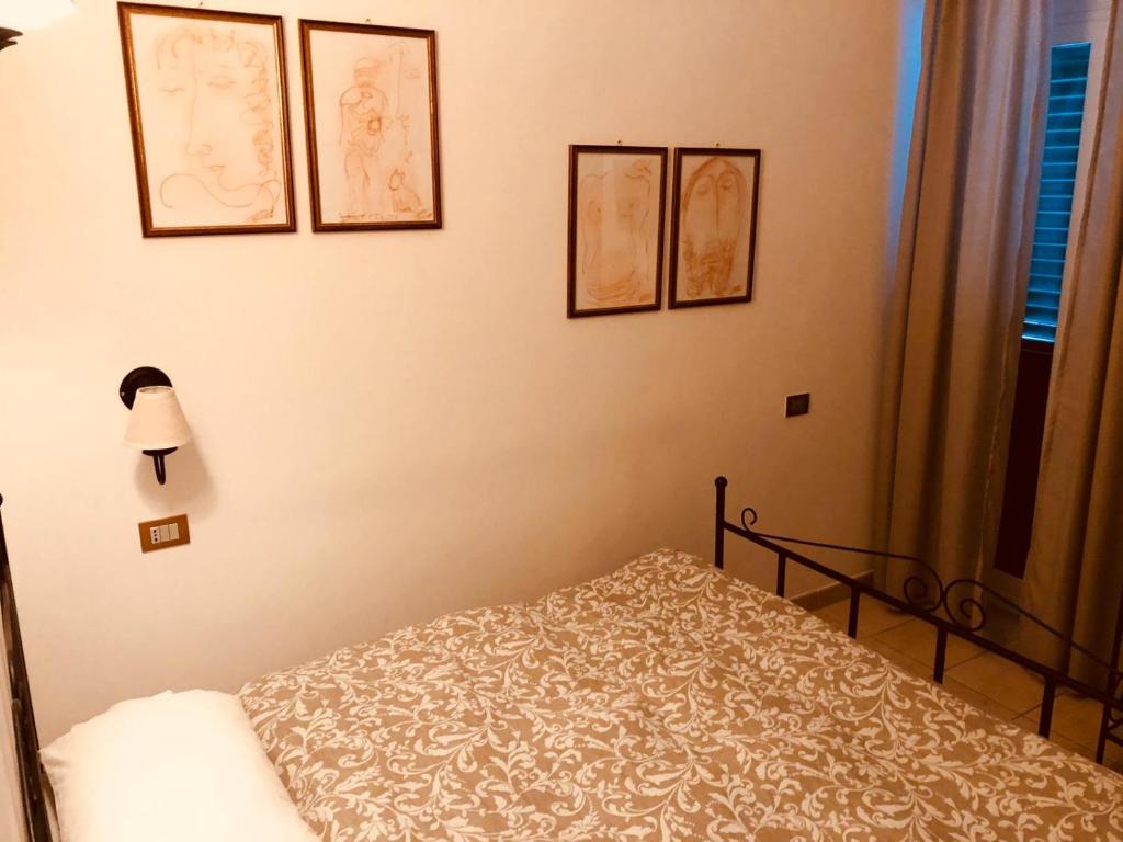 Postel nebo postele na pokoji v ubytování Le Antiche Porte