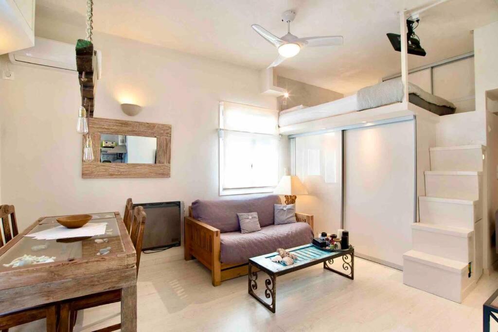 a living room with a couch and a table at Paros Stylish central loft in Parikia