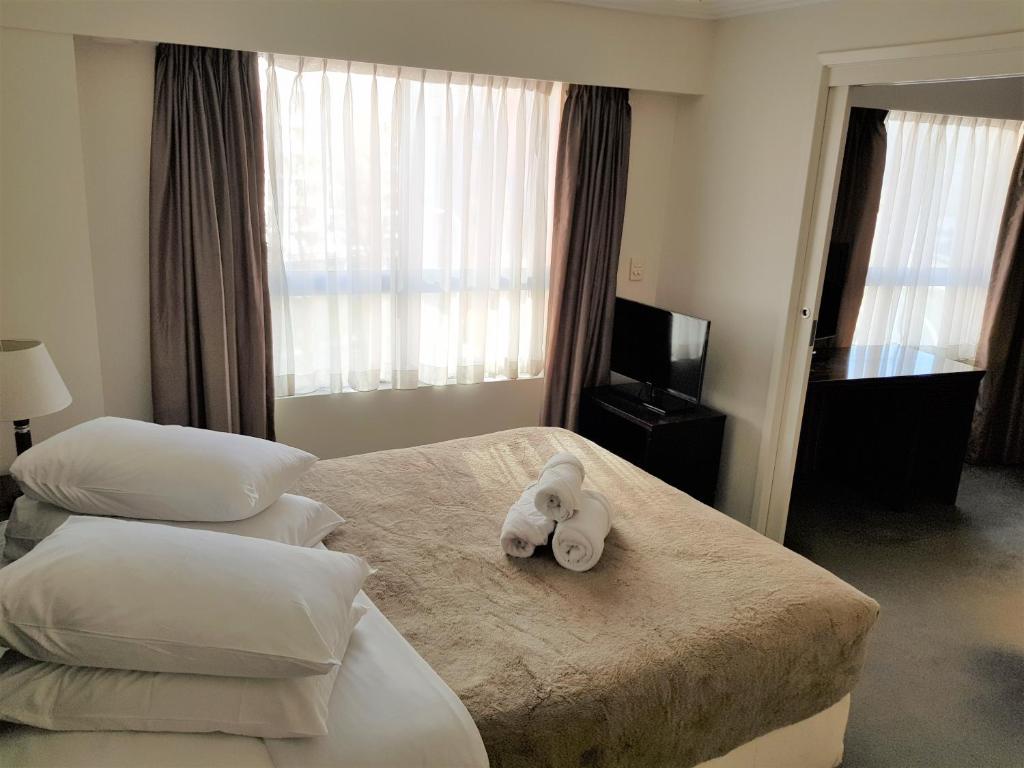 um quarto de hotel com uma cama com uma toalha em Accommodation Sydney 38 Harbour Street Sydney em Sydney