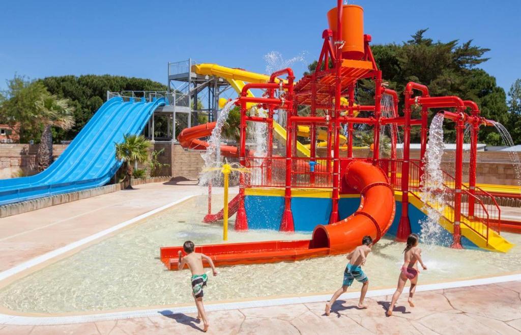 a group of children playing in a water park at Mobile Homes by KelAir at Camping La Sirene in Argelès-sur-Mer