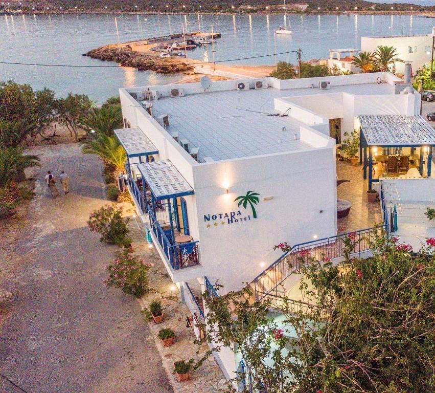 an aerial view of a white building next to the water at Hotel Notara in Diakofti