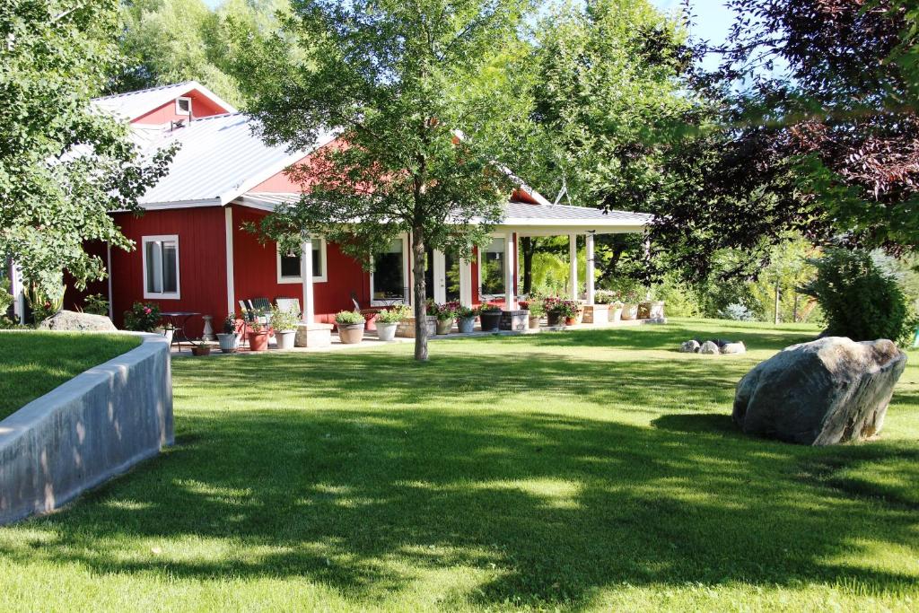 a red house with a large rock in the yard at Pleasant Valley in Rice