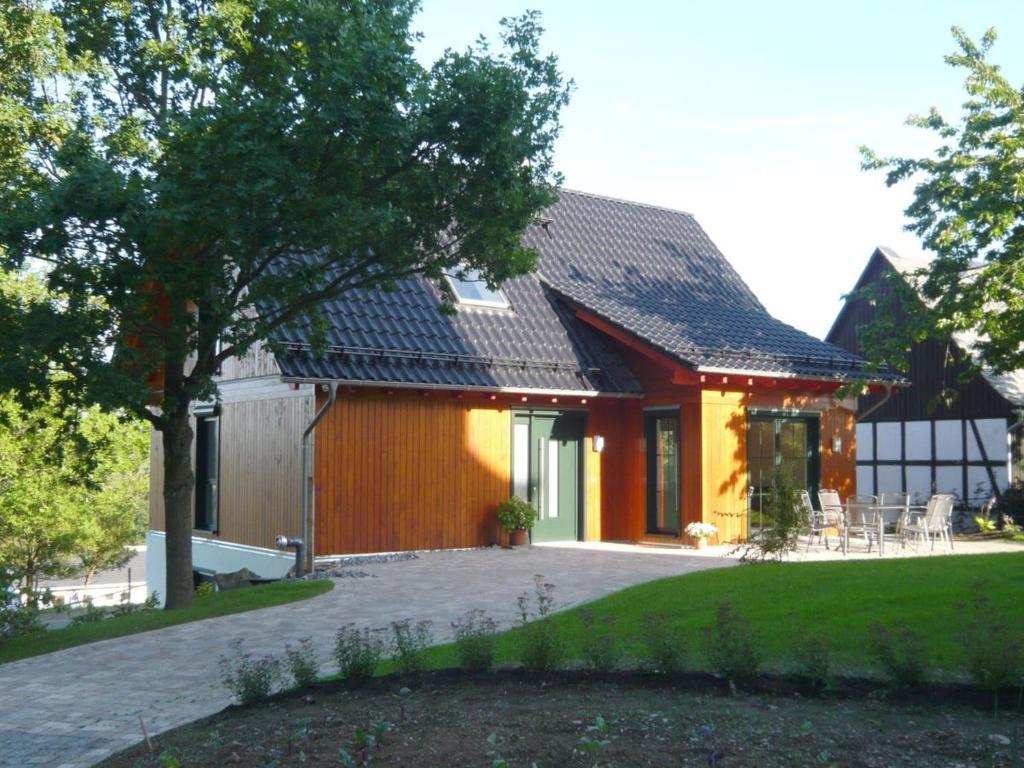 a house with a brick driveway in front of it at Ferienhaus Wasserfall in Bestwig