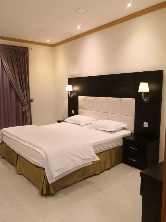 Postel nebo postele na pokoji v ubytování روح الأصيلة للشقق المخدومة Roh Alaseilah Serviced Apartments