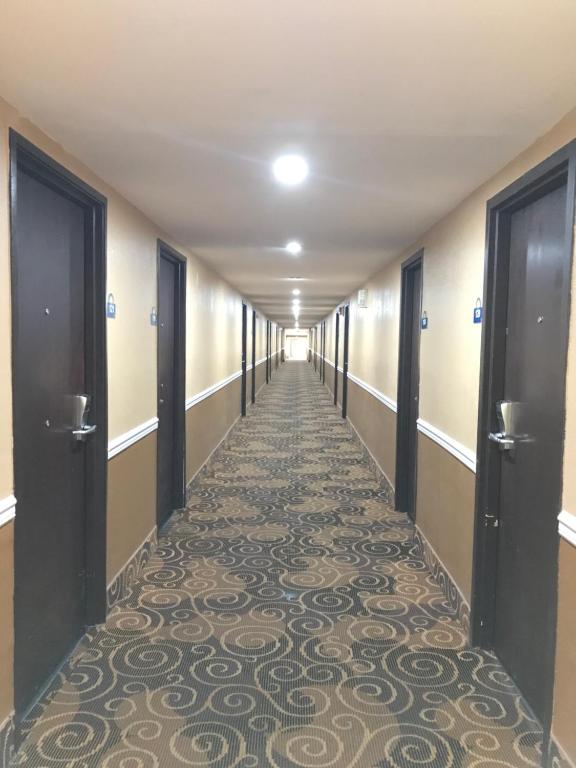 a hallway of a hospital with a carpeted corridor at Days Inn by Wyndham Joplin in Joplin