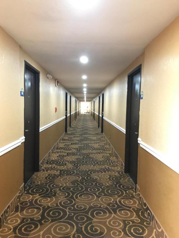 a long hallway with a carpeted floor in a building at Days Inn by Wyndham Joplin in Joplin