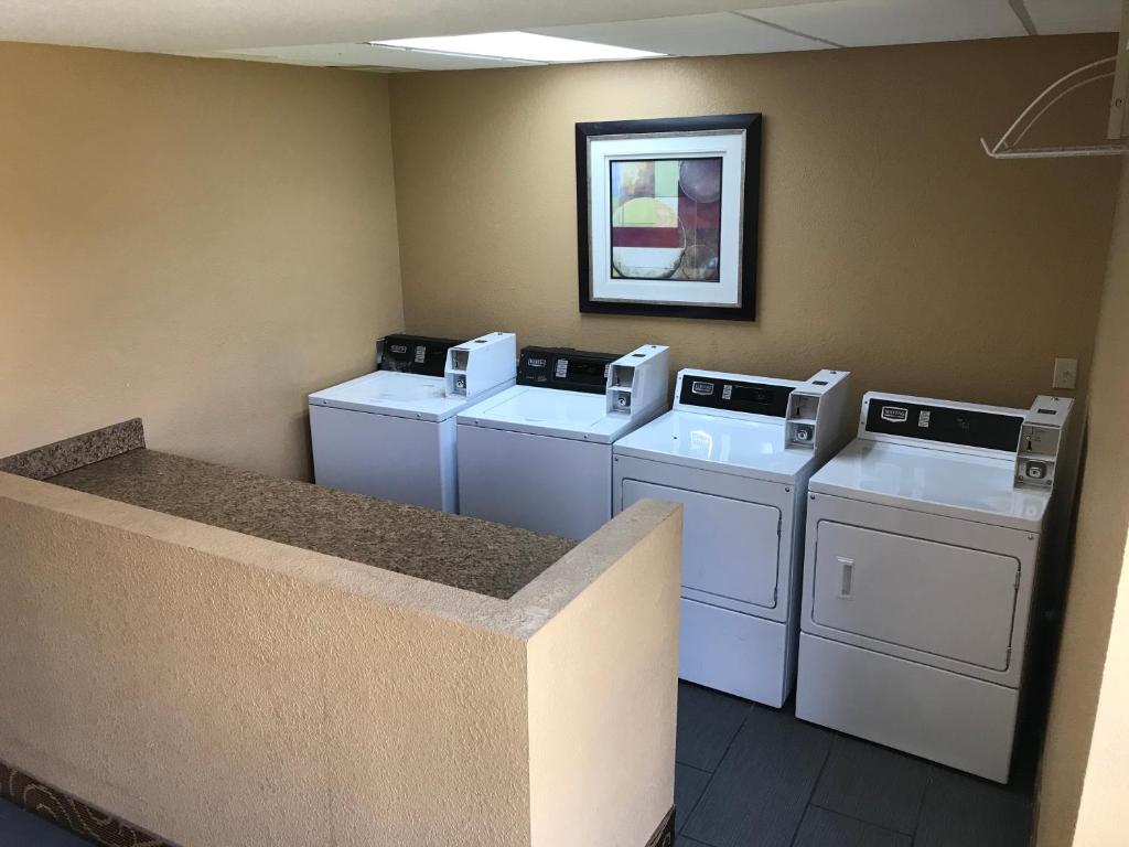 four washers and dryers in a laundry room at Days Inn by Wyndham Joplin in Joplin