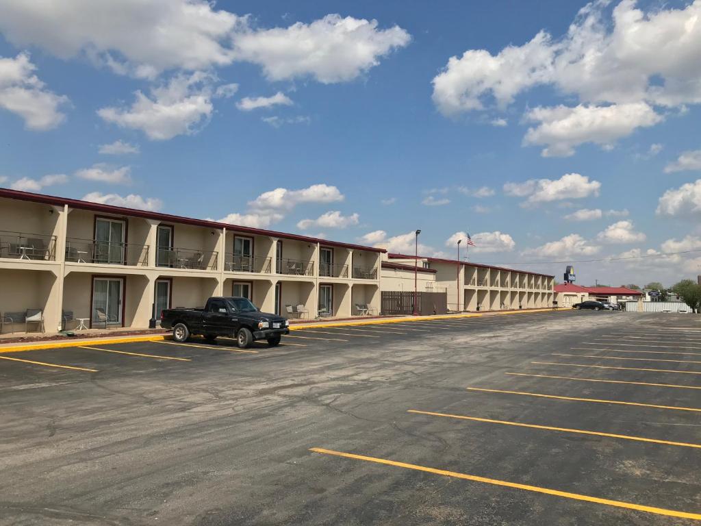 an empty parking lot in front of a hotel at Days Inn by Wyndham Joplin in Joplin