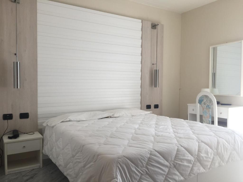 Posteľ alebo postele v izbe v ubytovaní Hotel Consuelo