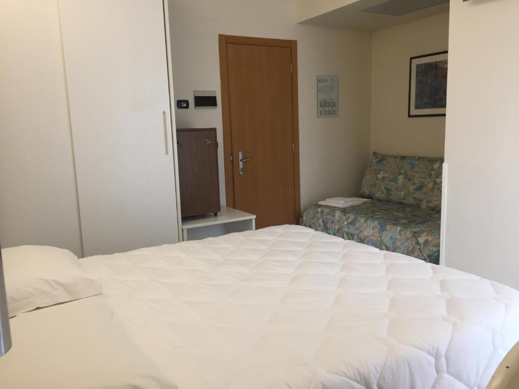 Posteľ alebo postele v izbe v ubytovaní Hotel Consuelo