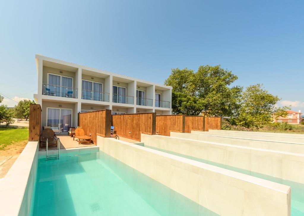 a swimming pool in front of a building at Belussi Exclusive Suites in Kypseli