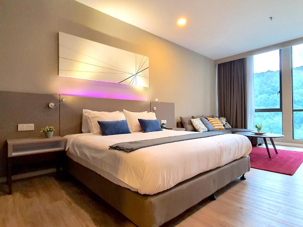a bedroom with a large bed with a large window at Empire Damansara Hotel Suites by Beestay in Petaling Jaya