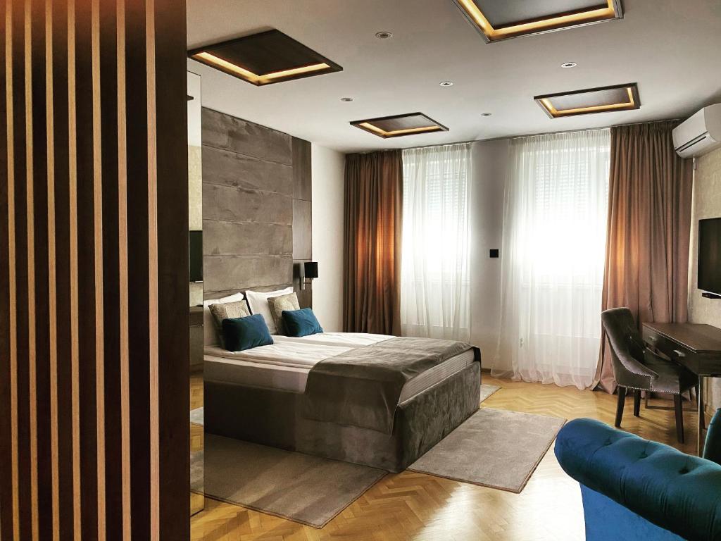 a hotel room with a bed and a desk at Aria Royal apartment in Belgrade