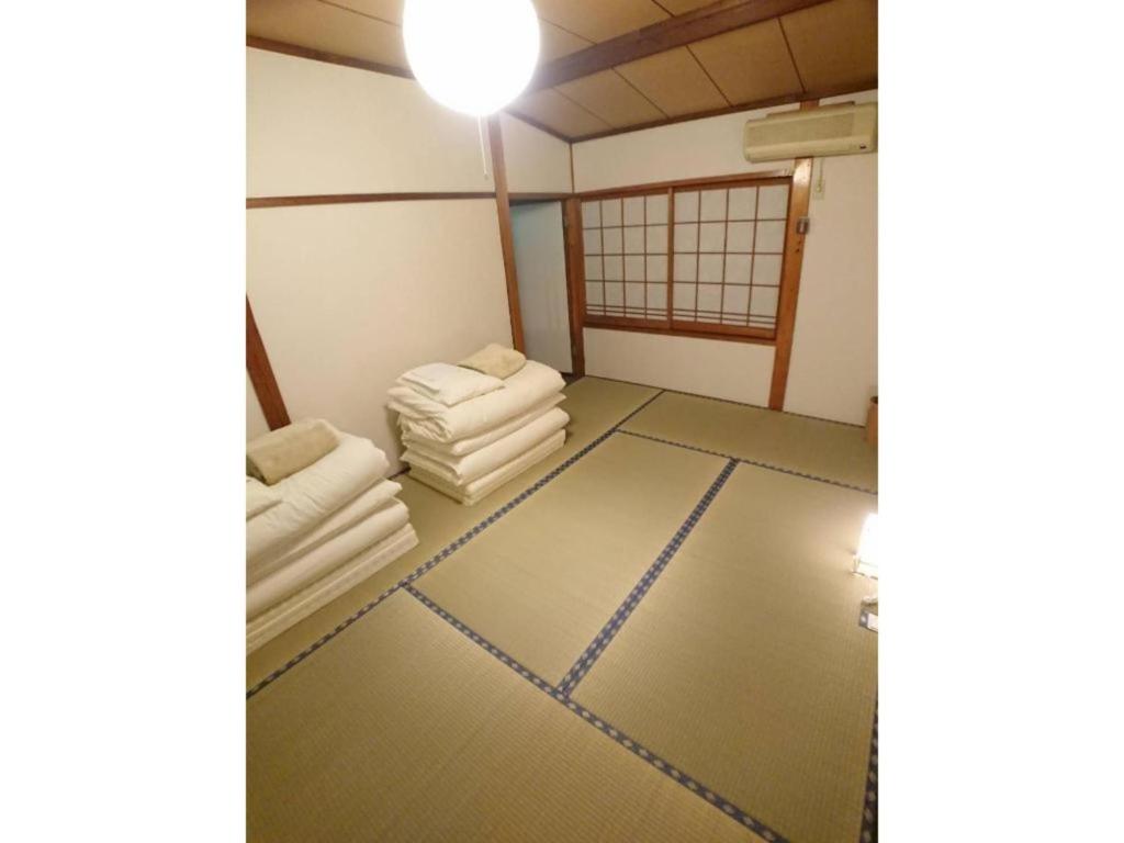 a room with two white chairs and a table at KINOSAKI KNOT - Vacation STAY 83610 in Toyooka