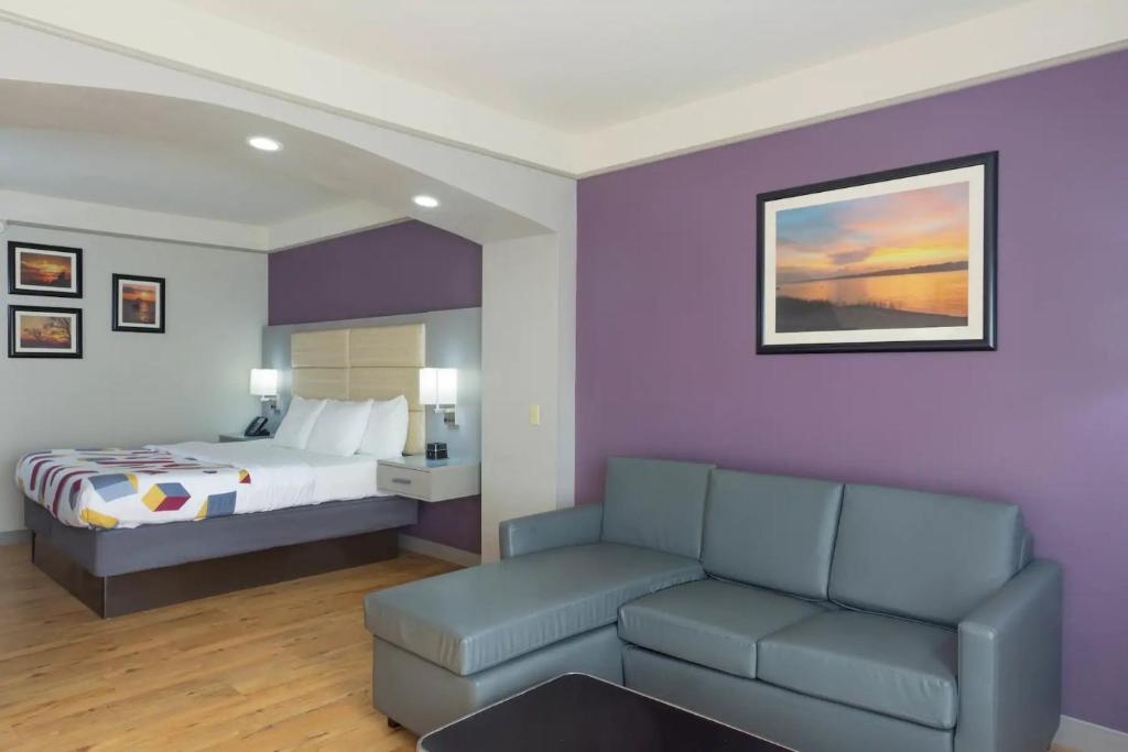 a hotel room with a bed and a couch at La Quinta by Wyndham Mobile - Daphne in Daphne