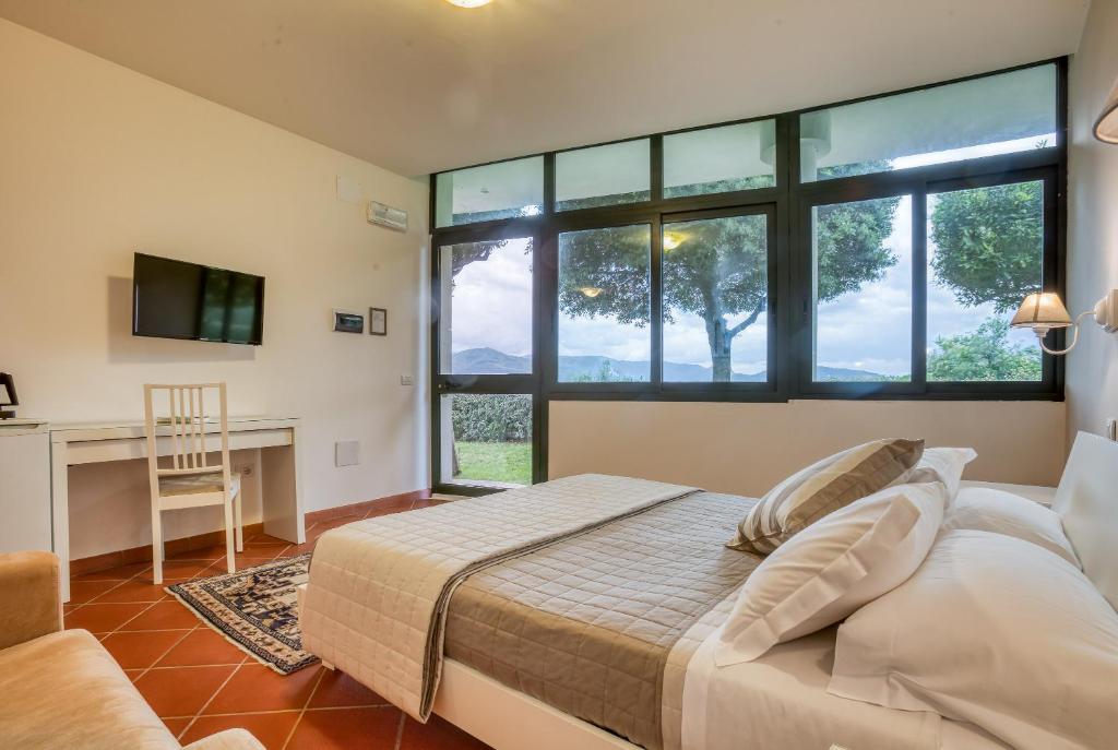 Postel nebo postele na pokoji v ubytování Hotel Villa De Santis
