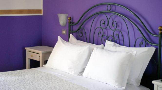 Postel nebo postele na pokoji v ubytování Hotel Benacus