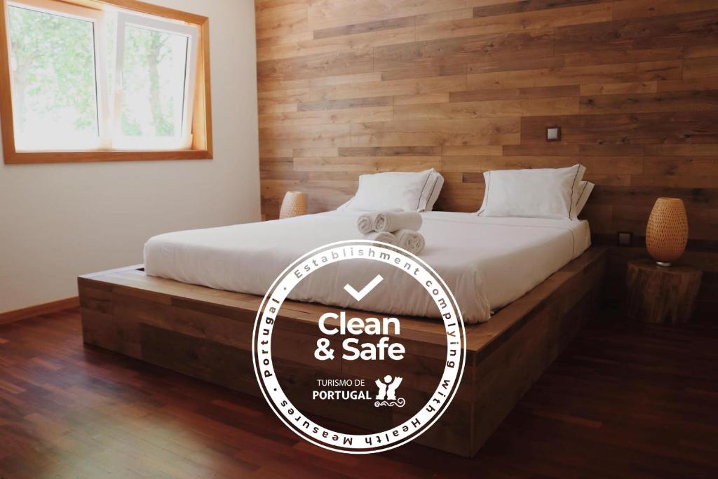a room with a bed with a sign that reads clean and safe at Oportocean Suites in Matosinhos