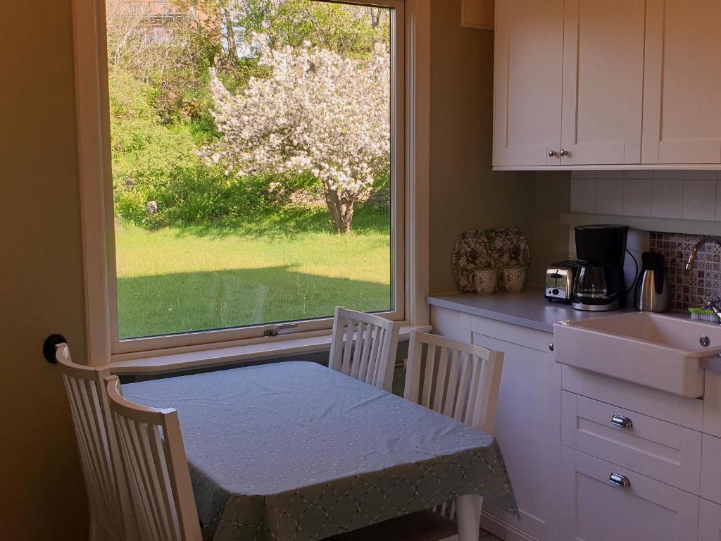 a kitchen with a table and two chairs and a window at Lilla Kari in Varberg