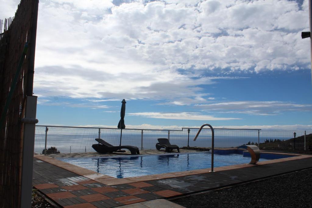 a swimming pool with a view of the ocean at Capellania in Tijarafe
