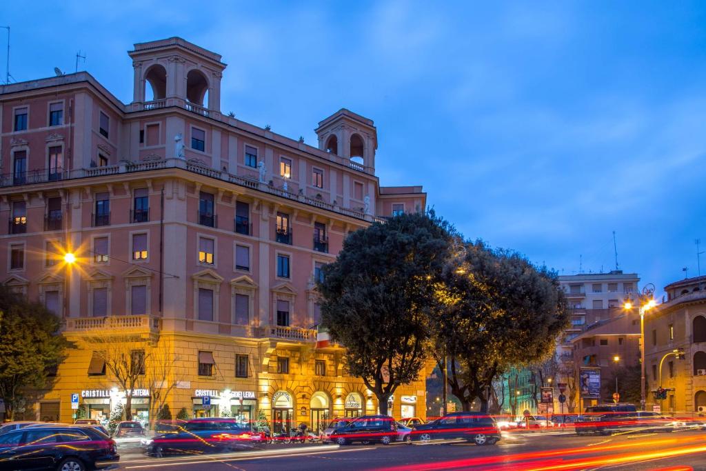 a large building on a city street at night at Best Western Hotel Astrid in Rome