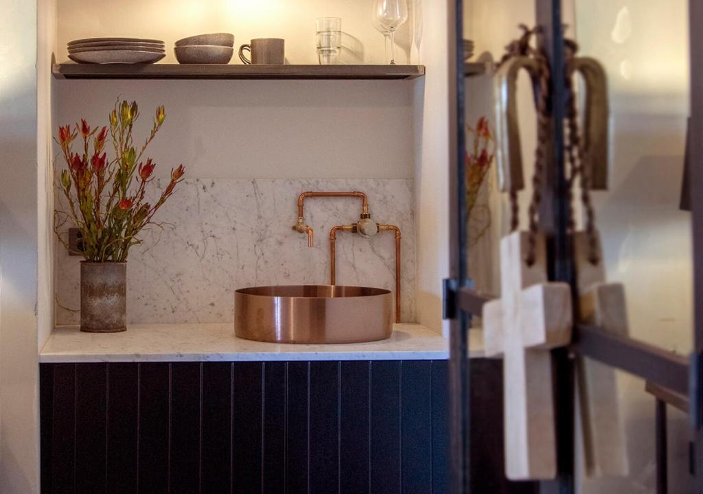 a copper sink on a counter in a kitchen at The Convent Hotel in Auckland