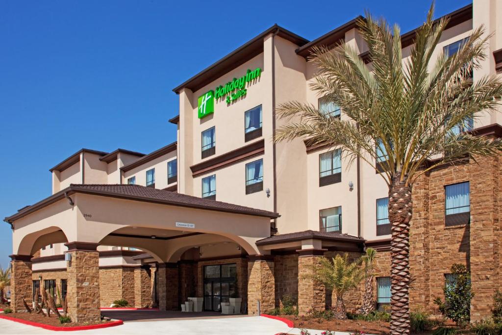 a hotel with a palm tree in front of it at Holiday Inn Hotel & Suites Lake Charles South, an IHG Hotel in Lake Charles