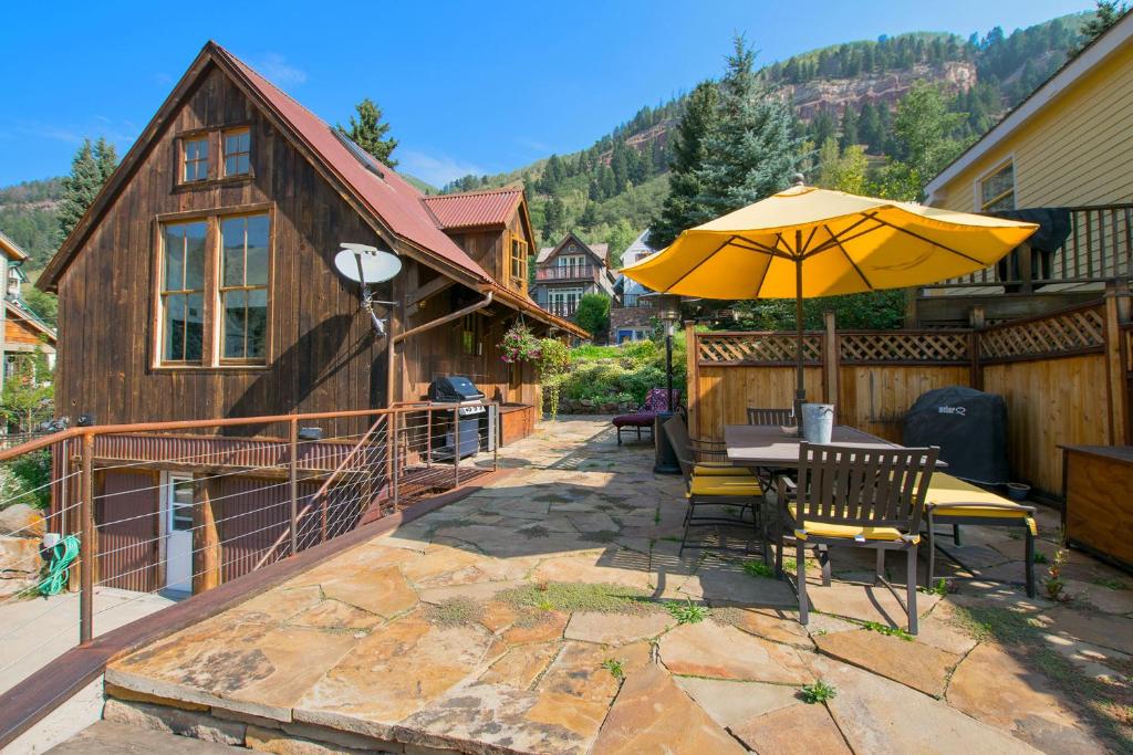 a patio with a table and an umbrella at Galena Chalet - Valley View 1 Br 1 Ba 2 Half Ba Sleeps 6 in Telluride