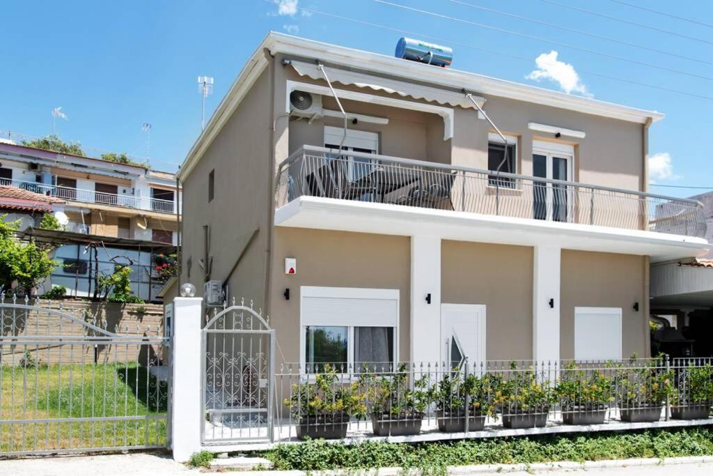 a house with a balcony and a fence at Endless sea view house in Nea Iraklia