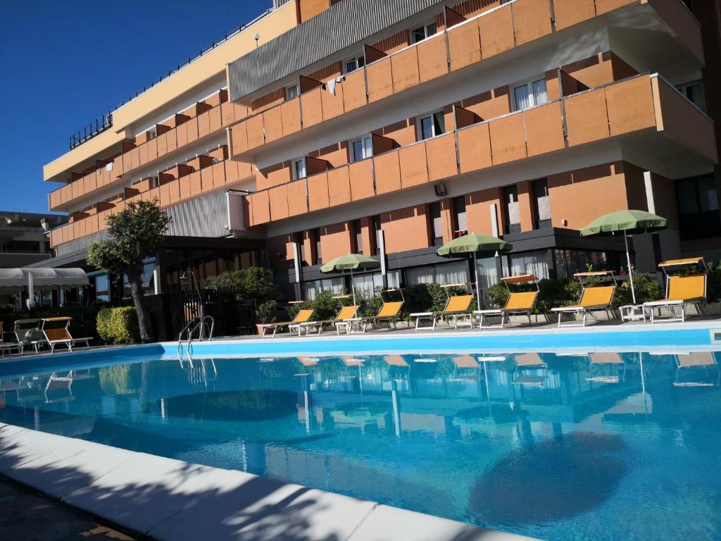 a swimming pool in front of a hotel at Park Hotel in Rimini