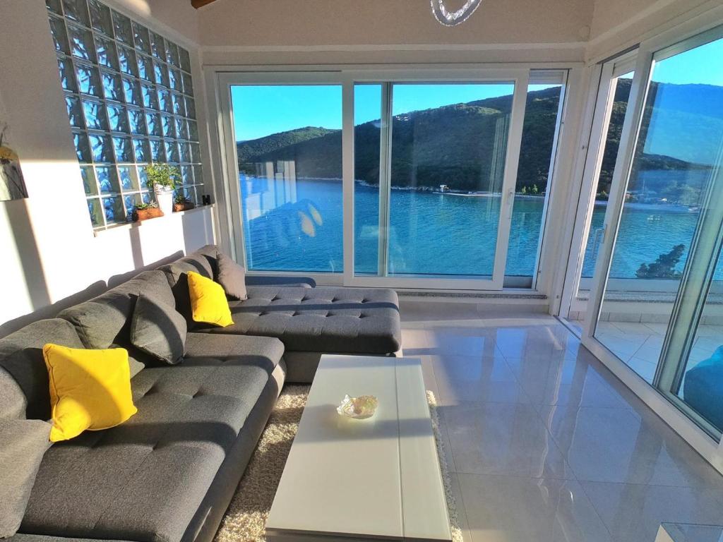 a living room with a couch and a view of the water at Apartment More 13 in Rabac