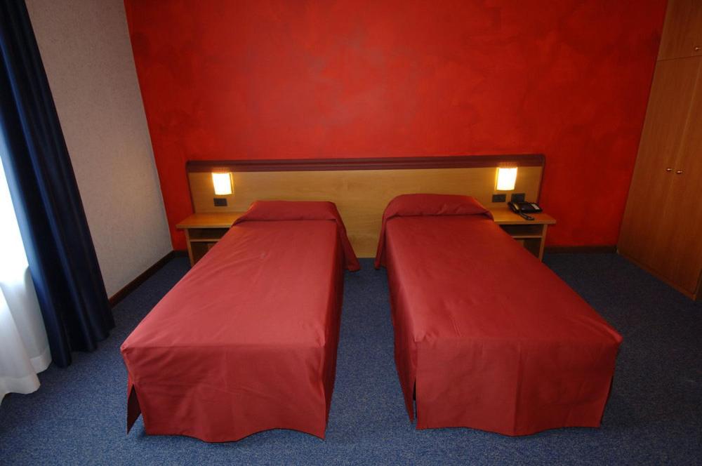 Postel nebo postele na pokoji v ubytování Hotel Residence Ducale