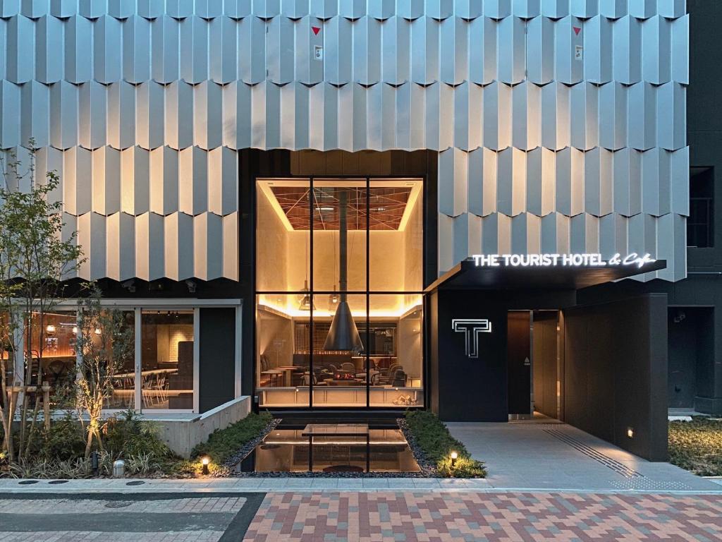 a building with a sign that reads the tudor hotel at THE TOURIST HOTEL & Cafe AKIHABARA in Tokyo