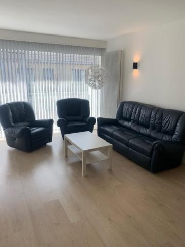 a living room with a couch and two chairs and a table at Cap Horn 0205 in Koksijde