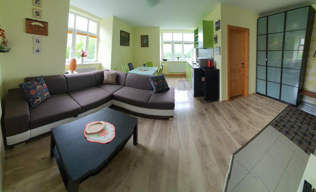 a living room with a couch and a table at Apartmán Helenka Stará Morava Tatranská Lomnica in Tatranská Lomnica