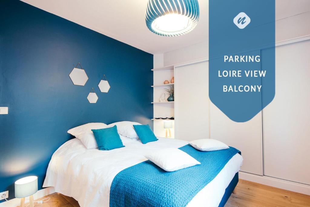 a blue bedroom with a bed with blue walls at The Rhuys - Cosy-balcony with superb Loire view - all on foot - Parking in Nantes