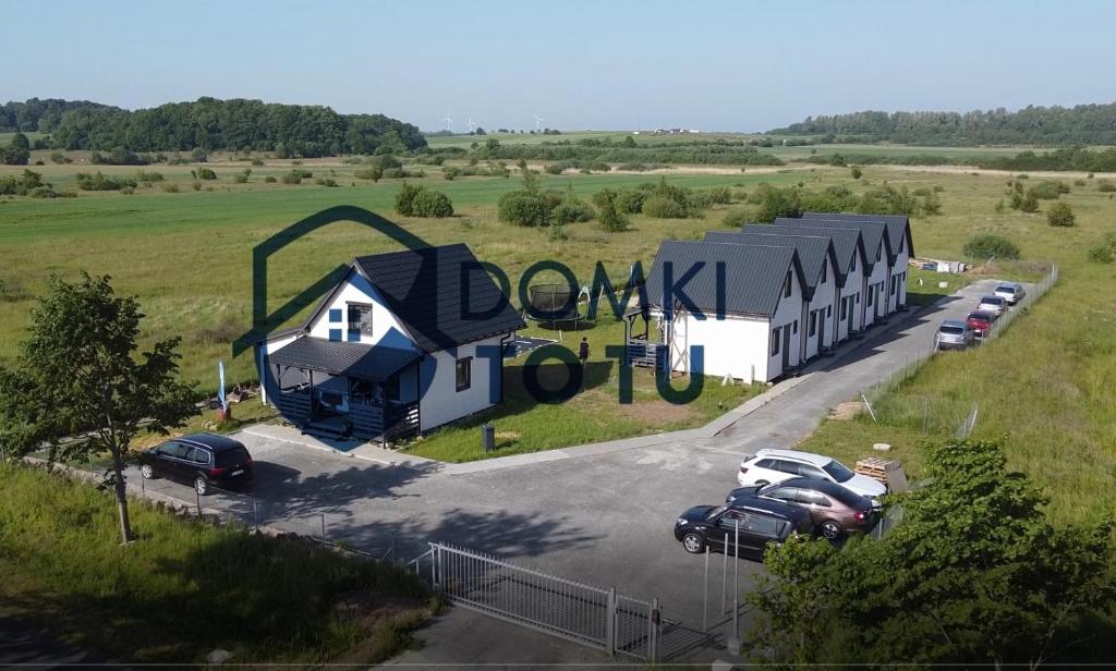 an aerial view of a building with a parking lot at DomkiToTu in Jarosławiec