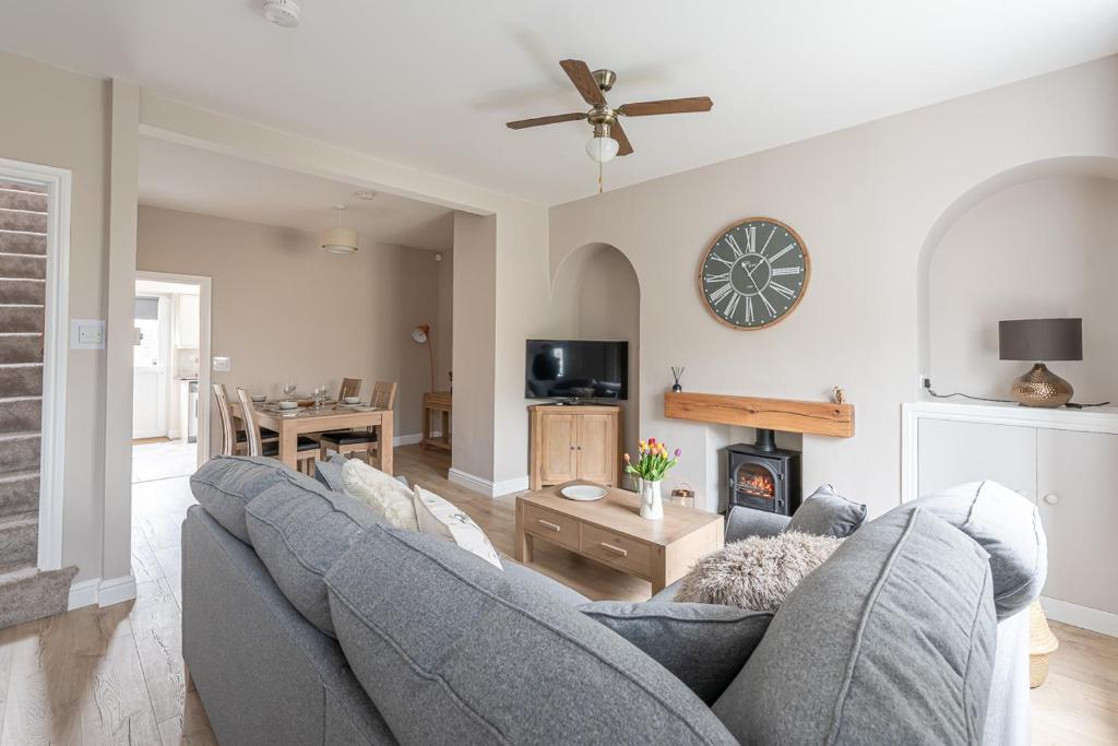 a living room with two couches and a fireplace at Dales Edge - Skipton in Skipton