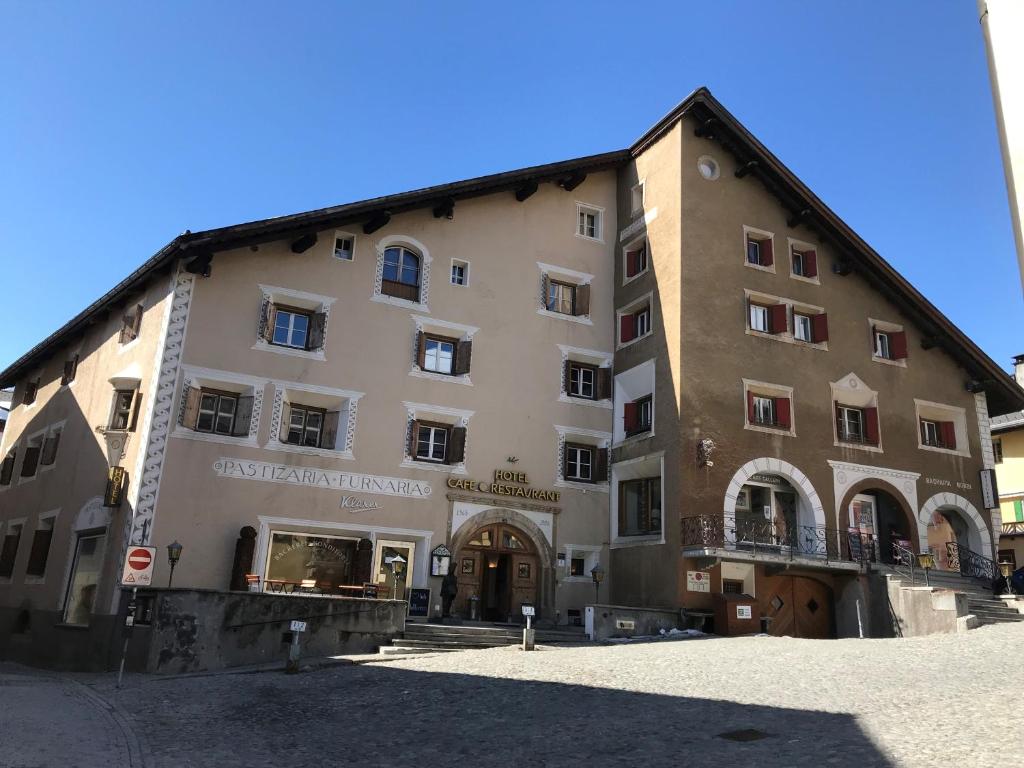 a large building in front of a building at Hotel Klarer in Zuoz