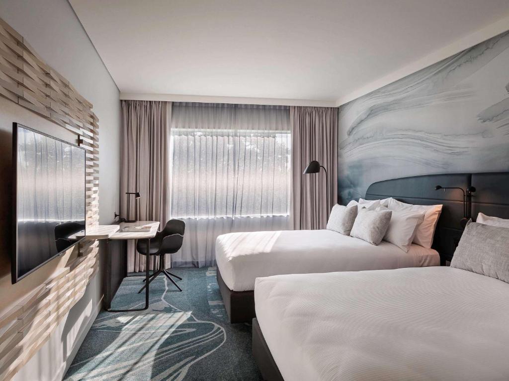 Postel nebo postele na pokoji v ubytování Novotel Tainui Hamilton