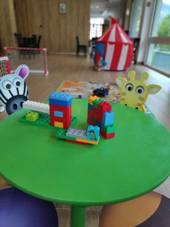 a green table with toys on top of it at Hotel Central in Engelberg