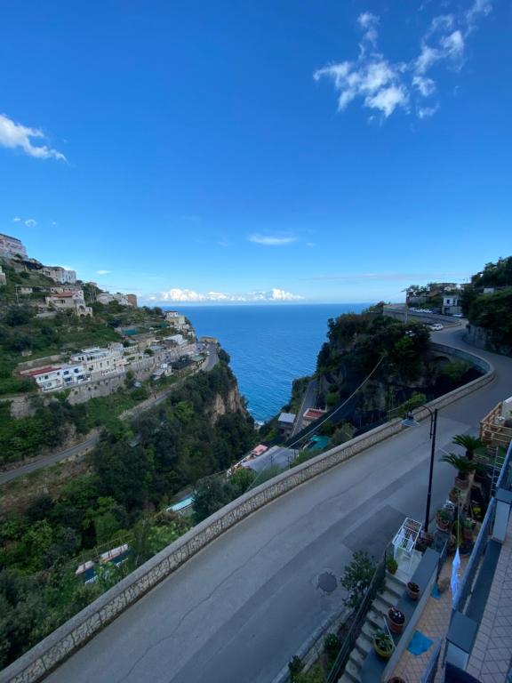 a view of a road with the ocean in the background at Matteo's House B&b in Amalfi