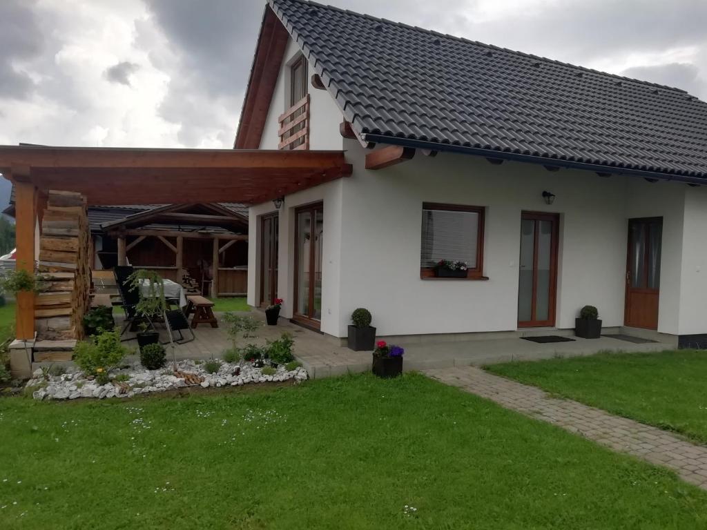 a white house with a pitched roof at Domček Michaela in Zuberec