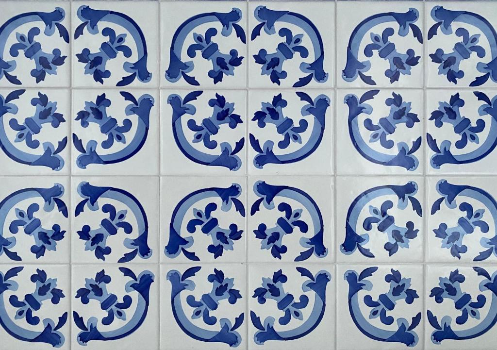 a blue and white tile pattern on a wall at Matteo's House B&b in Amalfi