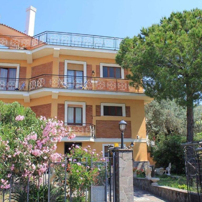 a yellow house with a fence in front of it at Villa Lembo in Agnone