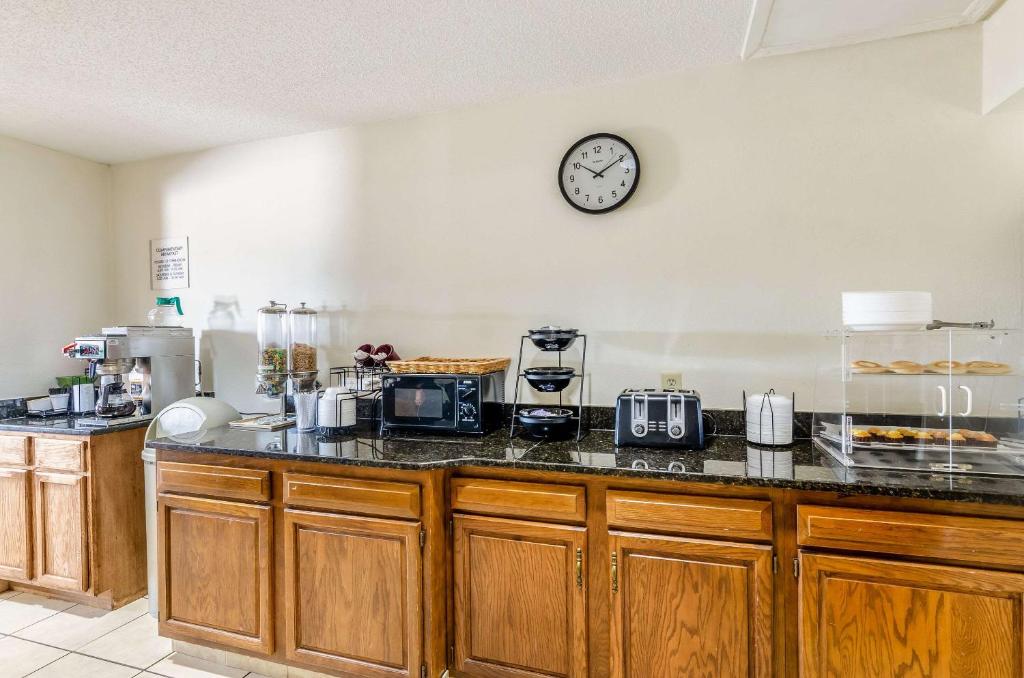 a kitchen with a counter with a clock on the wall at Econo Lodge Glade Springs I-81 in Glade Spring
