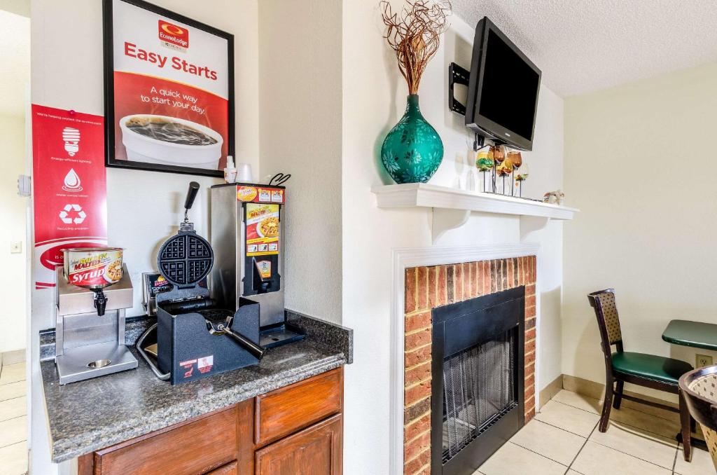 a living room with a fireplace and a television at Econo Lodge Glade Springs I-81 in Glade Spring