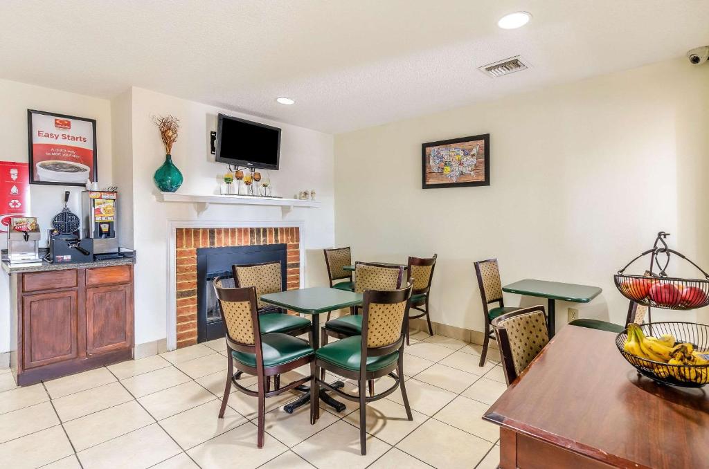 a dining room with a table and chairs and a fireplace at Econo Lodge Glade Springs I-81 in Glade Spring